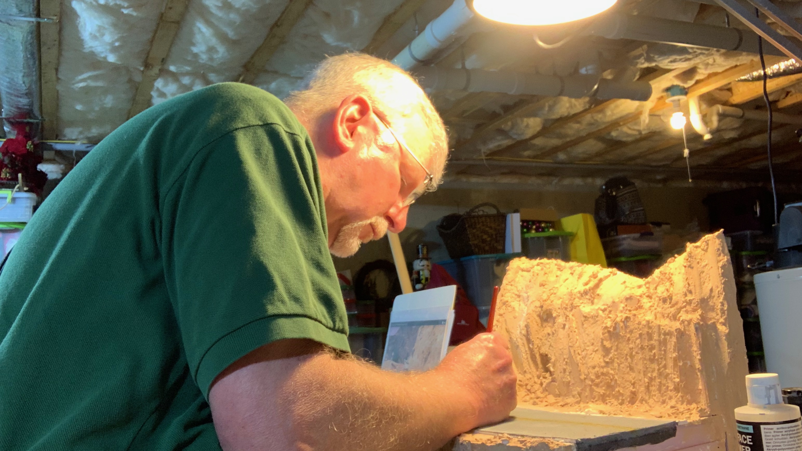 Jay working on a scale-model diorama at his workbench